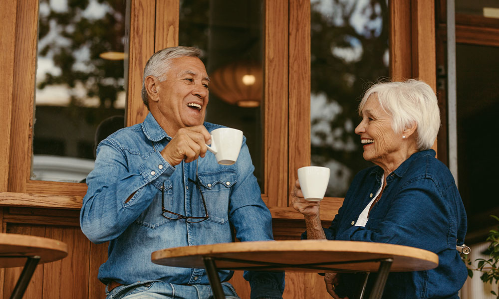 Older man and woman enjoying coffee together
